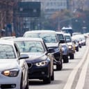 Cars in a long queue on a busy city street