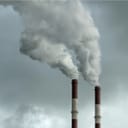 Thick smoke coming out of two industrial chimneys