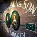 Old Jameson Distillery wall with a logo and two paintings