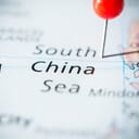 A pin placed on political map pointing to South China Sea