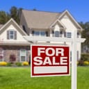 A 'for sale' sign in front a house