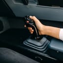 Person operating an airplane joystick