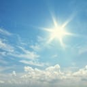 the sun shining in a clear blue sky