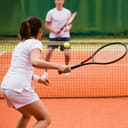young lady playing tennis
