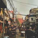 A busy street in India with people and motorcycles