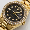 Golden rolex watch with the bezel embedded with diamonds