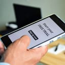 close-up of a smartphone showing a message that reads 'Start your free trial. Sign up now'