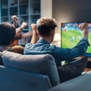 a group of friends watching a football match on a TV