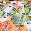 a stack of various Euro banknotes displaying 10, 100 and 50 Euro bills