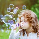 A little girl blowing bubbles
