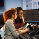 Two female developers looking at computer screens