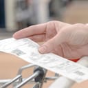 close-up of a woman's hand holding her shopping receipt