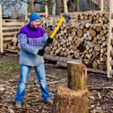 Man chopping wood outdoors in cold weather