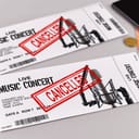 Two concert tickets with a large, red "Cancelled" stamp on them