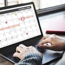 Person checking their schedule on laptop