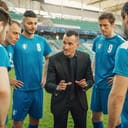 A soccer coach talking with his team