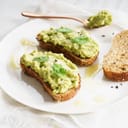 A highly nutritious breakfast toast topped with smashed avocado.