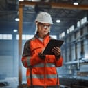 A female engineer working on a tablet while at a site
