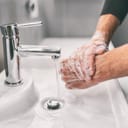 man washing hands with soap as a preventive measure against the spread of virus