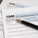 close-up of U.S. Individual Income Tax Return Form 1040 with a pen on it
