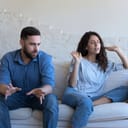 Angry couple talking in emotional conflict, arguing, shouting. Annoyed worried husband and wife disputing, discussing problems, divorce, abuse, break up, going through relationship crisis