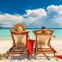Couple in loungers on a tropical beach at Maldives