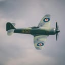 Hawker Hurricane WWII plane flying on a cloudy day