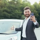 A successful and happy man excitedly brags about buying a new car.