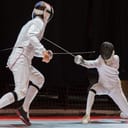 Two athletes fencing on stage
