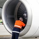 Mechanic inspecting an airplane's jet