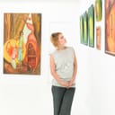 Woman looking at artwork hung on a wall