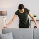 Woman measuring the headrest of a sofa