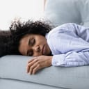 Woman sleeping on sofa