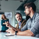 Man talking at a meeting with coworkers