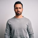 A man frowning and looking directly at the camera