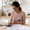 A smiling young woman sorting out her finances