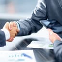 Two businessmen closing a deal with a handshake