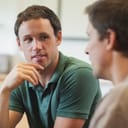close-up of two men engaged in conversation