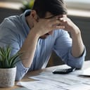 A distressed young man going over his finances