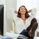 Woman happily resting her feet on the work desk