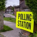 A yellow sign designates a polling station for voters during the British General Election and local elections.