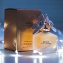 A bottle of "DAISY" perfume by Marc Jacobs with the accompanying box