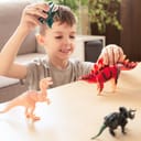 happy boy playing with new dinosaurs toys in a spacious, well-lit living room