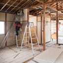 A man doing indoor renovations to a house
