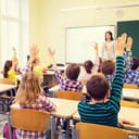 Classroom full of pupils raising their hands