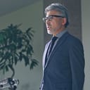 A man in a suit giving a speech