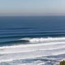 Waves Ocean Large Swells Crashing Large ocean wave swells crashing on shallow coastline from distant storms out over the blue horizon