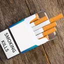 An open cigarette box with a "Smoking Kills" sign on them