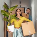 Smiling young couple moving into their new home