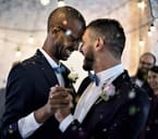 Wedding couple touching their brows while embraced in a dance